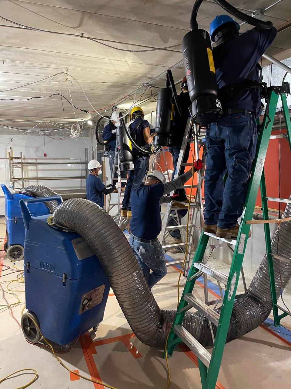 AH-CHOO HEPA crew on ladders cleaning commercial ductwork