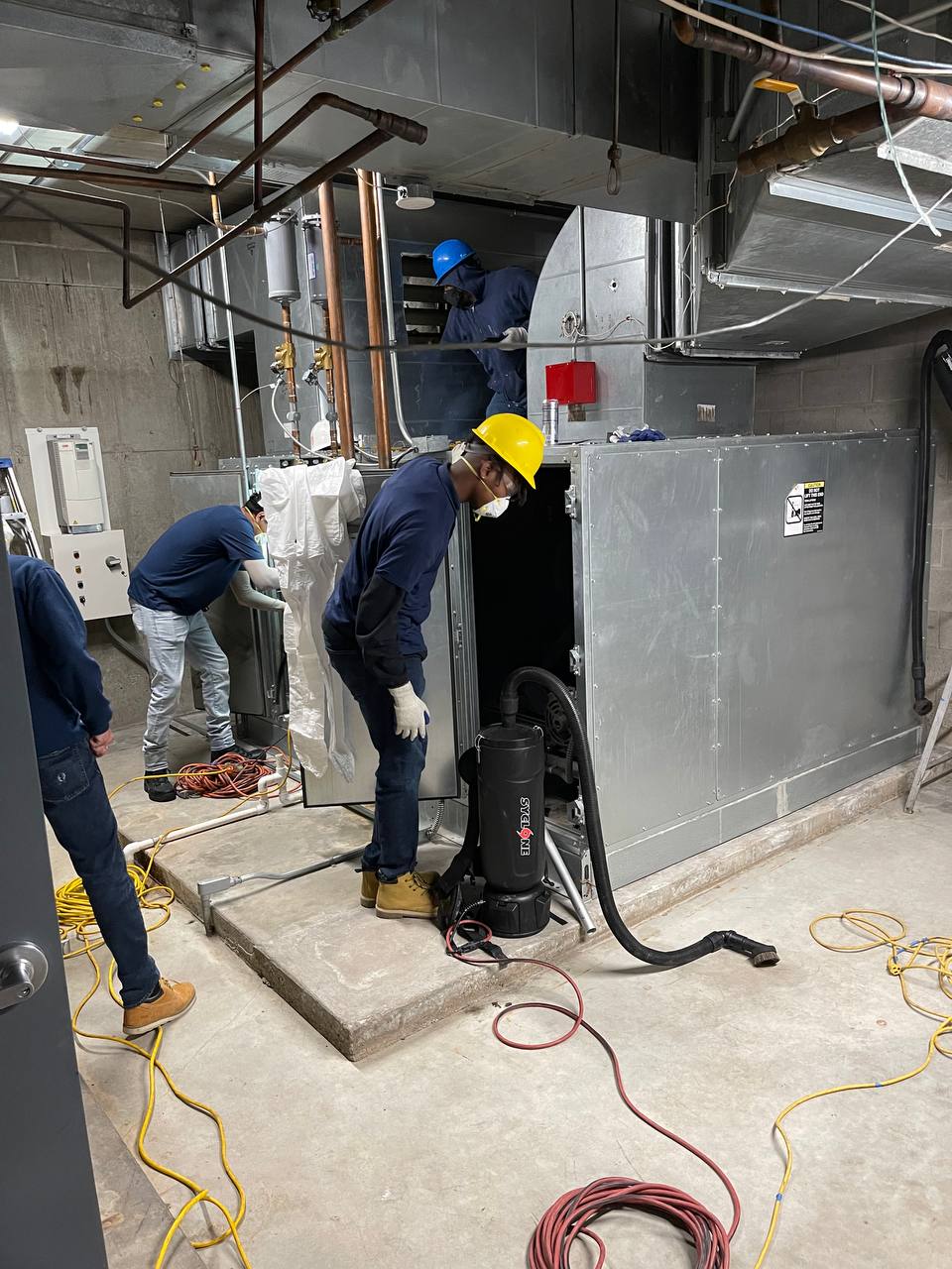 AH-CHOO technicians cleaning commercial HVAC mechanical room