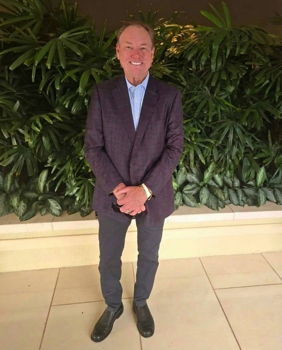 Vernon Eagle dressed formally against a luxury green backdrop